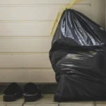 a trash bag leaned up against the door