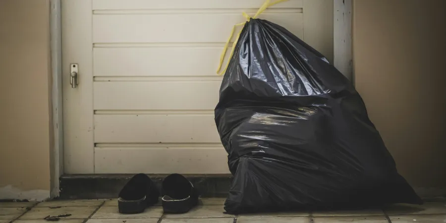 a trash bag leaned up against the door