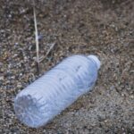 plastic bottle lying on sand