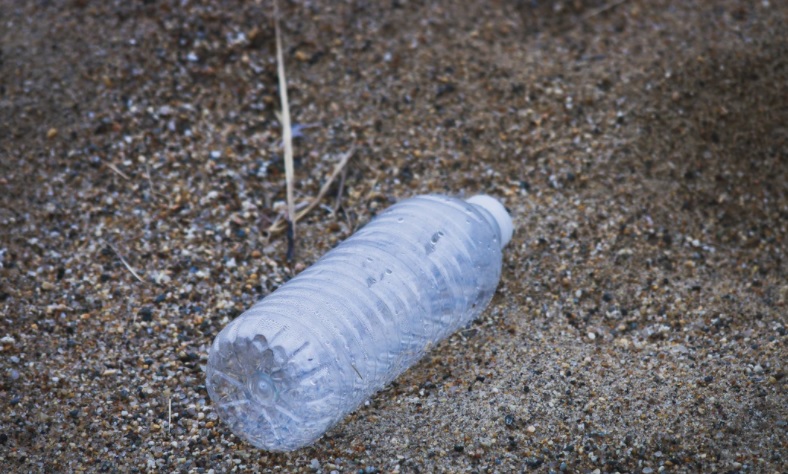 plastic bottle lying on sand