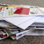 a pile of junk mail stacked in a disorderly way