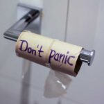 toilet paper roll with don't panic written on it