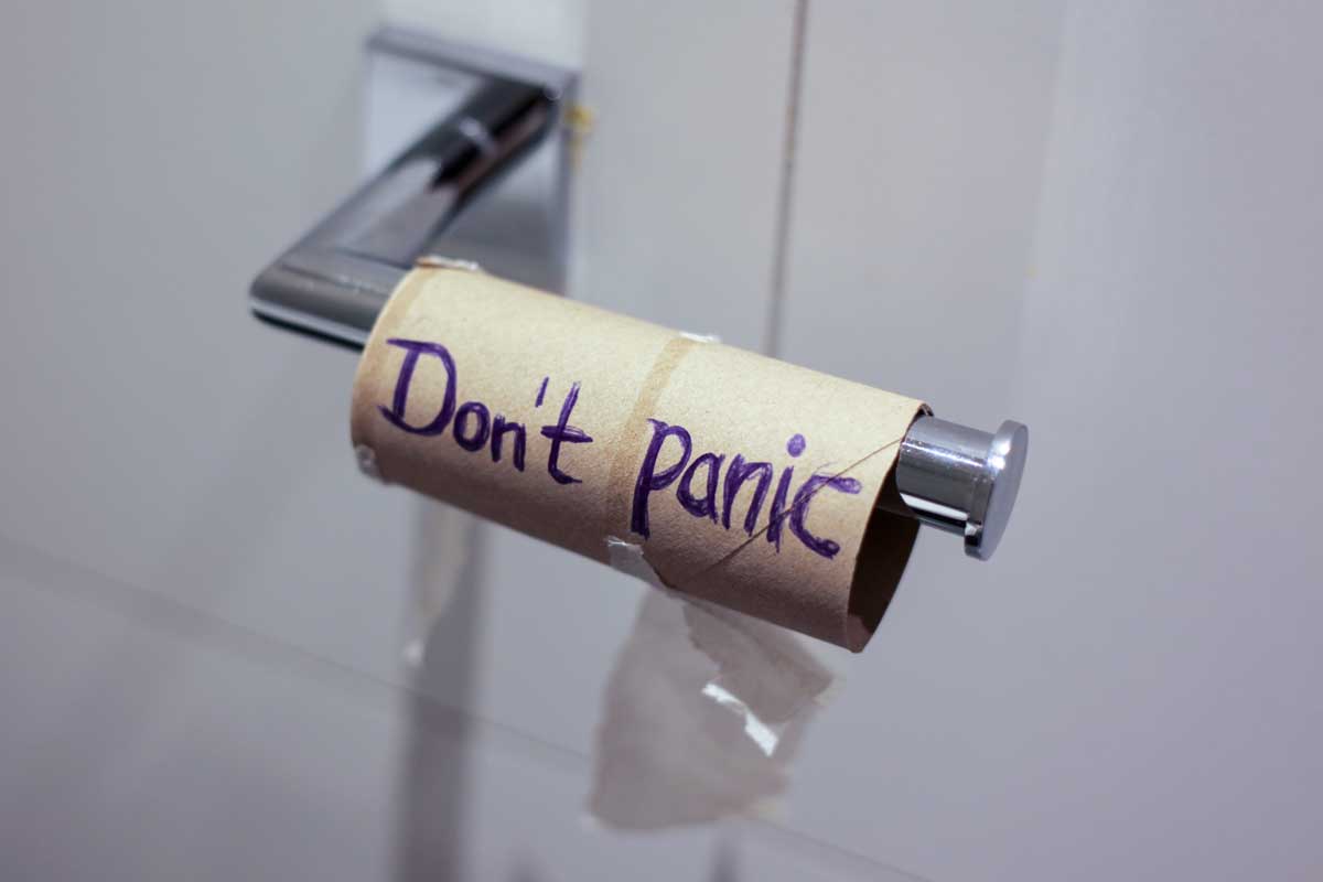 toilet paper roll with don't panic written on it