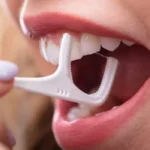 woman using a floss pick
