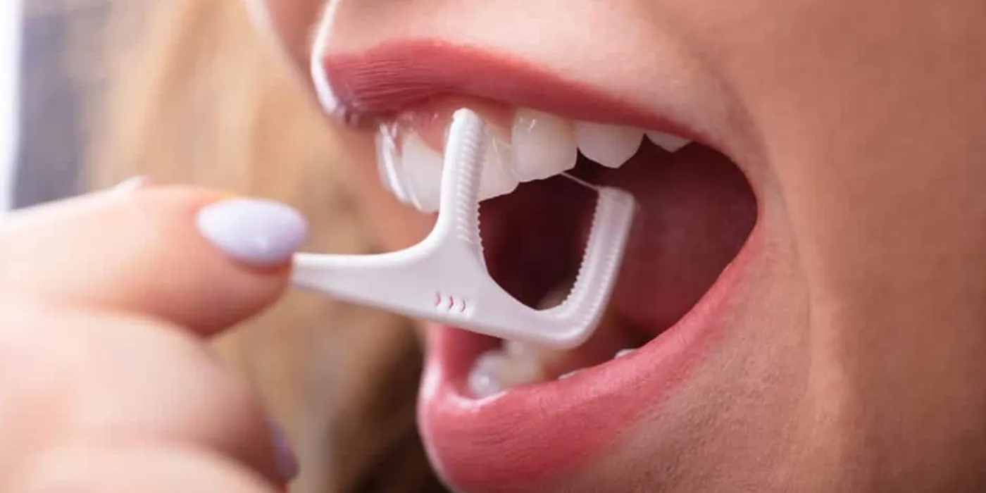 woman using a floss pick