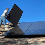 a worker installing solar panels