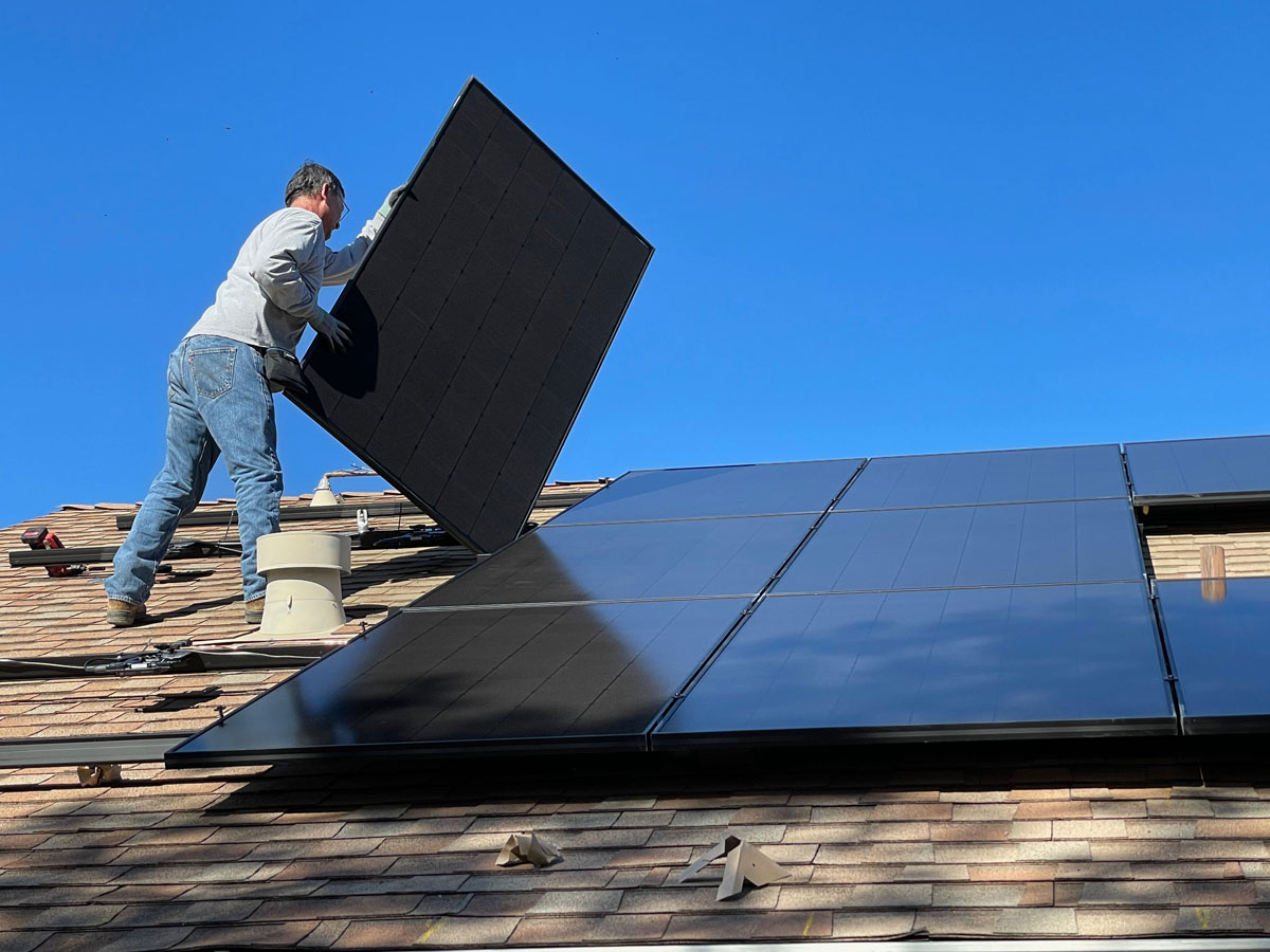 a worker installing solar panels