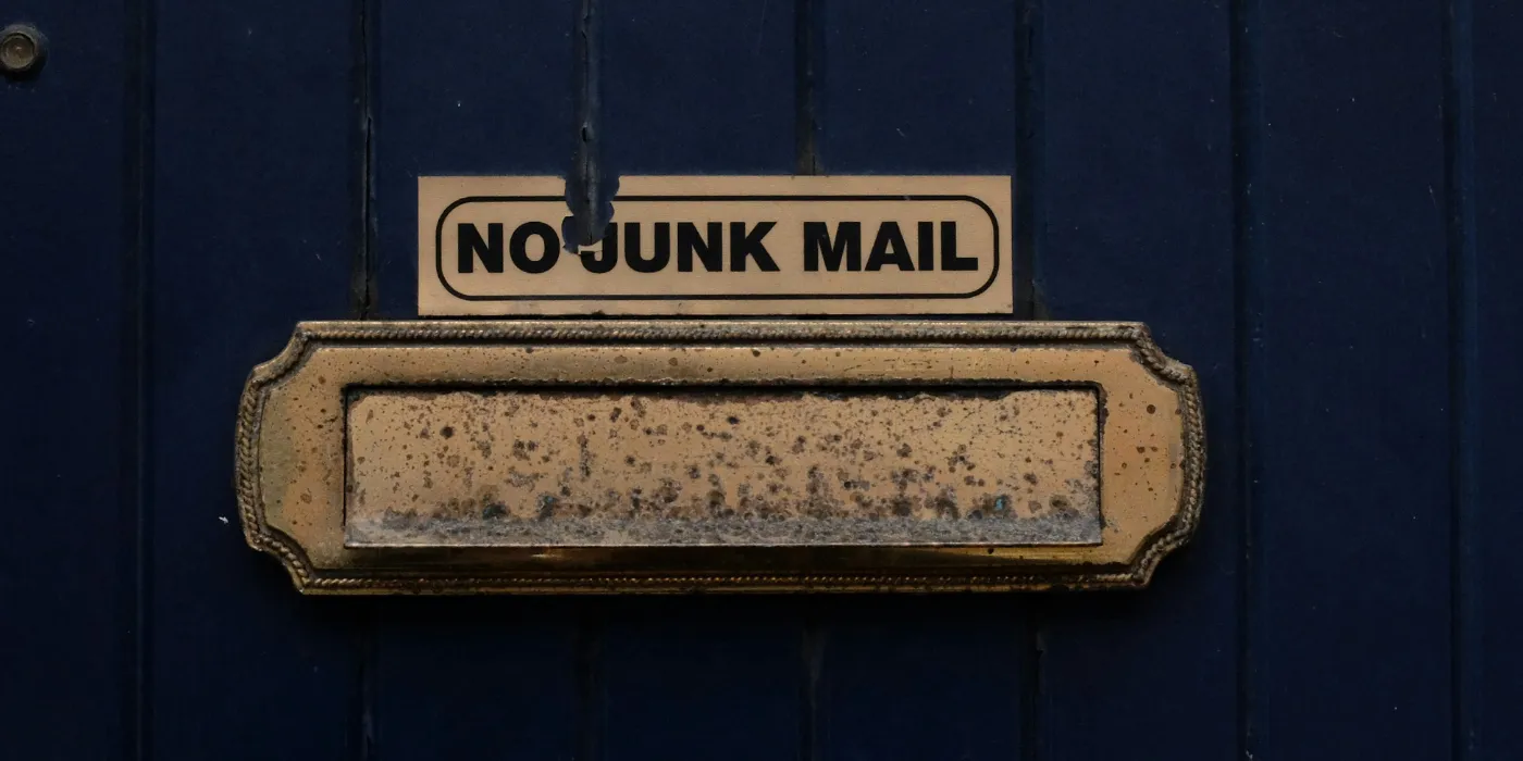 mail slot with a no junk mail sign